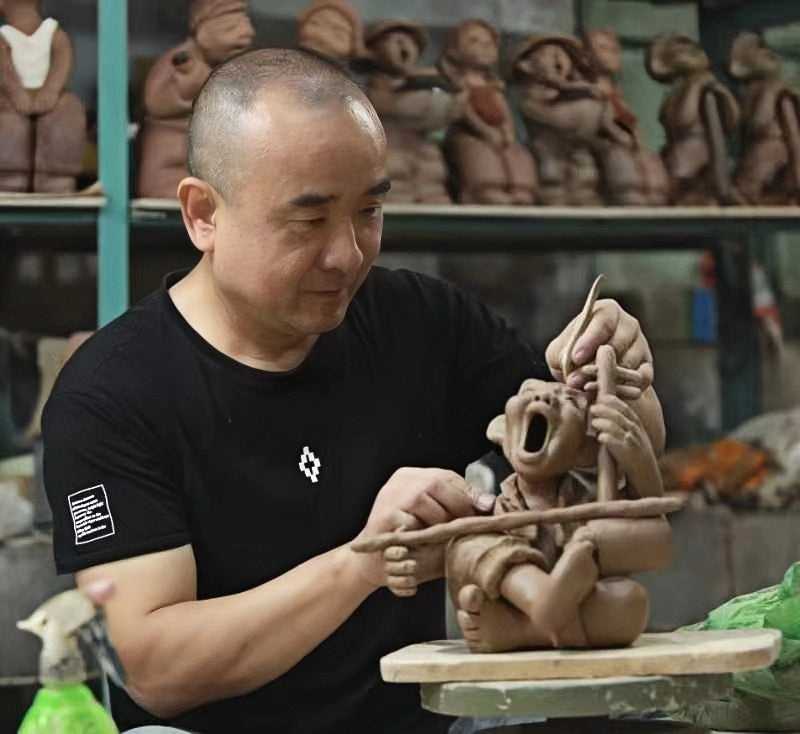 Huyunping working on a handmade clay figurine in the Clay Tales studio, shaping expressive details through traditional handcraft techniques